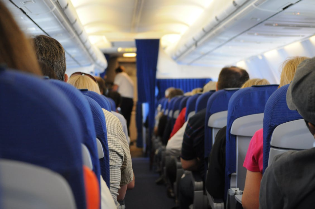 people sitting in an airplane’s economy class