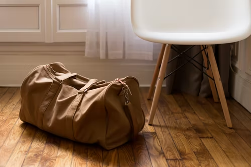 a carry-on bag on a wooden floor