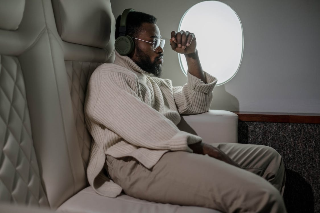 man sitting in a window seat on business class