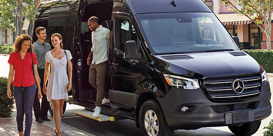 passengers getting off a black van