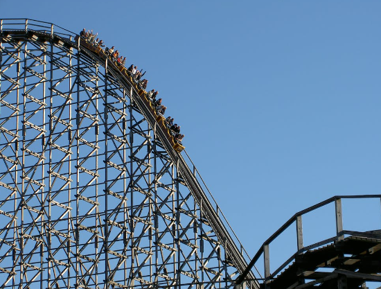 People sitting on a rollercoaster.