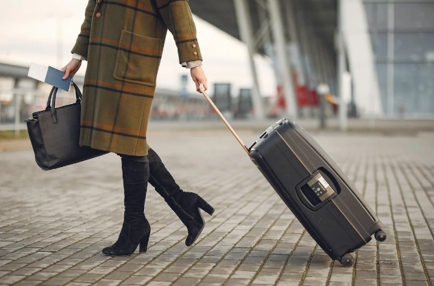 Woman carrying luggage.