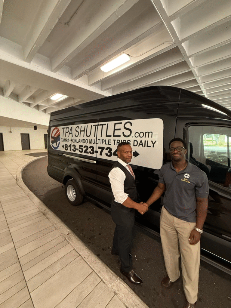 Two men shaking hands by TPA Shuttles van.
