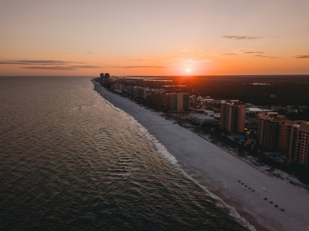 Sunset over coastline cityscape and ocean view